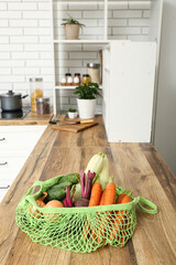 Wall Mural - Mesh bag with different fresh vegetables on counter in kitchen