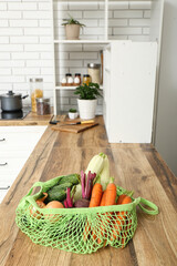 Poster - Mesh bag with different fresh vegetables on counter in kitchen