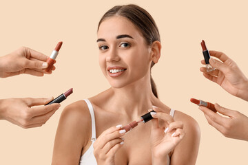 Poster - Young woman with lipsticks on light background