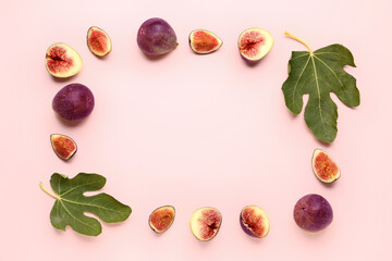 Wall Mural - Frame made of fresh ripe figs and leaves on pink background