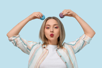 Sticker - Funny young woman with sweet macaroons on blue background