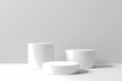 © AgungRikhi - Three white cylinder podiums on a white background. Minimalist product display stand or pedestal for advertising.
