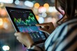 © CHAWA GEN - A businesswoman analyzing market data on a tablet with charts and graphs visible, set against a bokeh background.