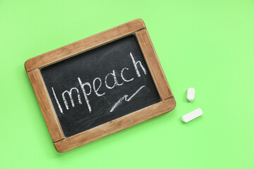 Wall Mural - Chalkboard with word IMPEACH on green background