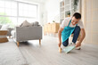 © Pixel-Shot - Male janitor sweeping floor in room