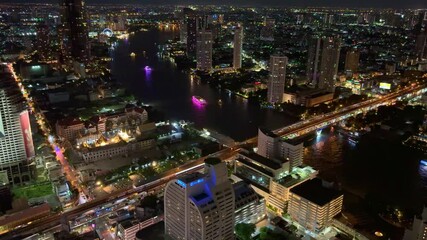 Wall Mural - Bangkok BKK the city that never sleeps colourful lights of the buildings shops streets cars of the city and urban skyline view from one of the tallest Sky Tower in BKK 