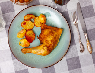 Wall Mural - Closeup of homemade baked chicken legs with potatoes on plate