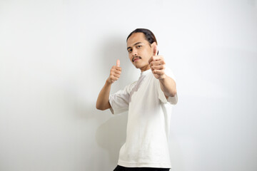 Young man wearing a white t-shirt. make okay movements with his hands. sign isolated on white background