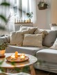 © Pascal - Modern boho interior of living room in cozy apartment. Simple cozy living room interior with light gray sofa, decorative pillows, wooden table with candles and natural decorations