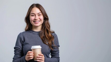 An active woman holding a coffee cup with a smile, standing against a simple background ideal for adding custom text or graphics , 