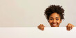 © XaMaps - Smiling woman peeking over a white edge, neutral white background.