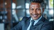 © volga - Confident businessman smiling in modern office