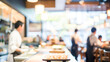 © soem - An abstract background of a sushi restaurant with blurred chefs preparing sushi and patrons sitting at the sushi bar