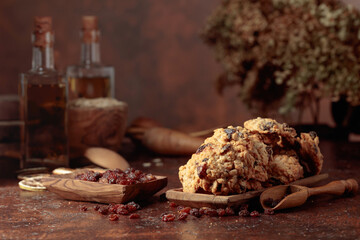 Oatmeal raisin cookies on a brown table.