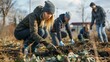 © antkevyv - People ages participating in community clean-up initiative armed with rakes shovels to remove debris from local park