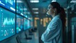 © Ruby Siam - A woman in a lab coat stands in a control room, analyzing data on large screens. She is focused and determined, looking at the information displayed.