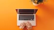 © naphat - Minimalistic woman hands typing on laptop, top view with orange background banner for website design and development service in flat lay style with copy space area. sharp focus and clear light , high