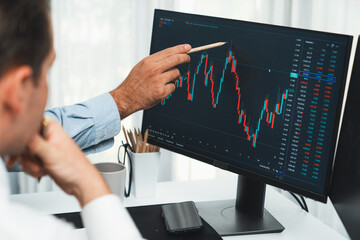 Wall Mural - Stock trader pointing highest stock market to present coworker on dynamic valued analysis research on real time monitor screen, cooperating business investment in financial company exchange. Sellable.