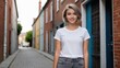 © QuoDesign - Teenage girl with short hair wearing white t-shirt and grey jeans standing in a city alley