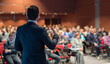 © kasto - Speaker at Business Conference with Public Presentations. Audience at the conference hall. Entrepreneurship club. Rear view. Panoramic composition. Background blur.