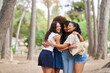 © Retamosa - A group of women hug each other in a park