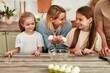 © Valerii Apetroaiei - Spending Time Together Mother and Daughters Enjoying Cooking Experience in the Kitchen