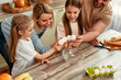 © Valerii Apetroaiei - Happy Family Cooking Together in the Kitchen with Children, Laughing, and Bonding
