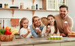 © Valerii Apetroaiei - A happy family cooking in a modern kitchen, bonding over meal preparation and enjoying quality time