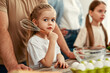 © Valerii Apetroaiei - In a heartwarming family moment, a little girl joyfully uses a whisk in the kitchen