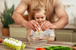© Valerii Apetroaiei - Father and daughter having fun in the kitchen, cracking eggs and cooking together
