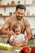 © Valerii Apetroaiei - Father and daughter having fun in the kitchen, cracking eggs and cooking together