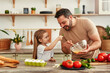 © Valerii Apetroaiei - Father and daughter bonding while cooking with fresh ingredients in the kitchen