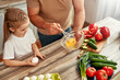 © Valerii Apetroaiei - Father and daughter bonding while cooking with fresh ingredients in the kitchen