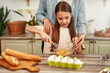 © Valerii Apetroaiei - A mother and daughter bond while baking in their kitchen, enjoying the activity together