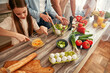 © Valerii Apetroaiei - Family spends quality time making a nutritious salad in their contemporary kitchen