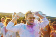 © maxbelchenko - Holi festival. Young people with colorful paint on clothes and bodies have fun together. Beach party. Friendship, rest, holidays.