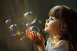 © happy_finch - A young girl watches soap bubbles float in the air, illuminated by the warm sunlight