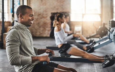 Wall Mural - Sports, gym and man on rowing machine for health, wellness and body workout with class. Endurance, exercise and male athlete on ergometer equipment for cardio cross training in fitness center.