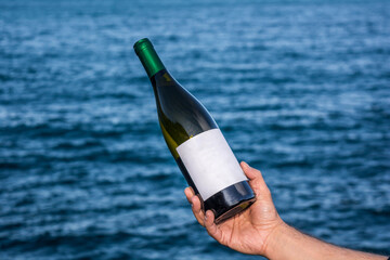 Wall Mural - Bottle of wine by the sea