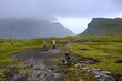 © Iwona - Mountain trip from Saksun village of Saksun to Tjornuvik on island of Streymoy. Silhouettes of hiking people on trail. Faroe Islands, Denmark