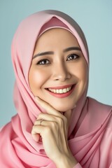 Wall Mural - A beautiful woman in pink hijab smiling.