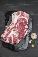 Wall Mural - Raw pork neck meat. Traditional ingredients for cooking food. Garlic cloves, fresh parsley