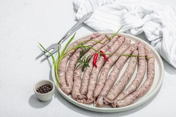 Wall Mural - Raw pork sausages ready to cook in barbecue. Spices and herbs, traditional ingredient for picnic