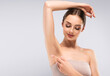 © Sofia Zhuravetc - Armpit epilation, lacer hair removal. Young woman holding her arms up and showing clean underarms, depilation smooth clear skin .Beauty cosmetology portrait.