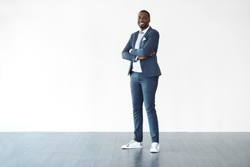 Poster - Arms crossed, business casual or space and portrait of man on studio white background with wooden floor. Confident, mockup and smile with happy person in work outfit for start of design career