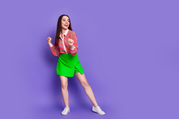 Wall Mural - Full body photo of attractive young woman dance enjoy disco dressed stylish pink clothes isolated on violet color background