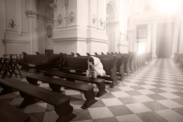 Girl sit on the bench in the church