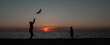 © aaalll3110 - happy family father and child daughter run with kite in the meadow. silhouettes on the background of the sea sunset. High quality photo.