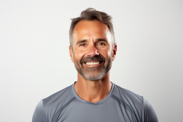 Wall Mural - Portrait of a grinning man in his 40s sporting a breathable mesh jersey isolated on white background