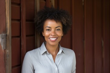 Sticker - Portrait of a happy afro-american woman in her 50s donning a classy polo shirt over rustic wooden wall